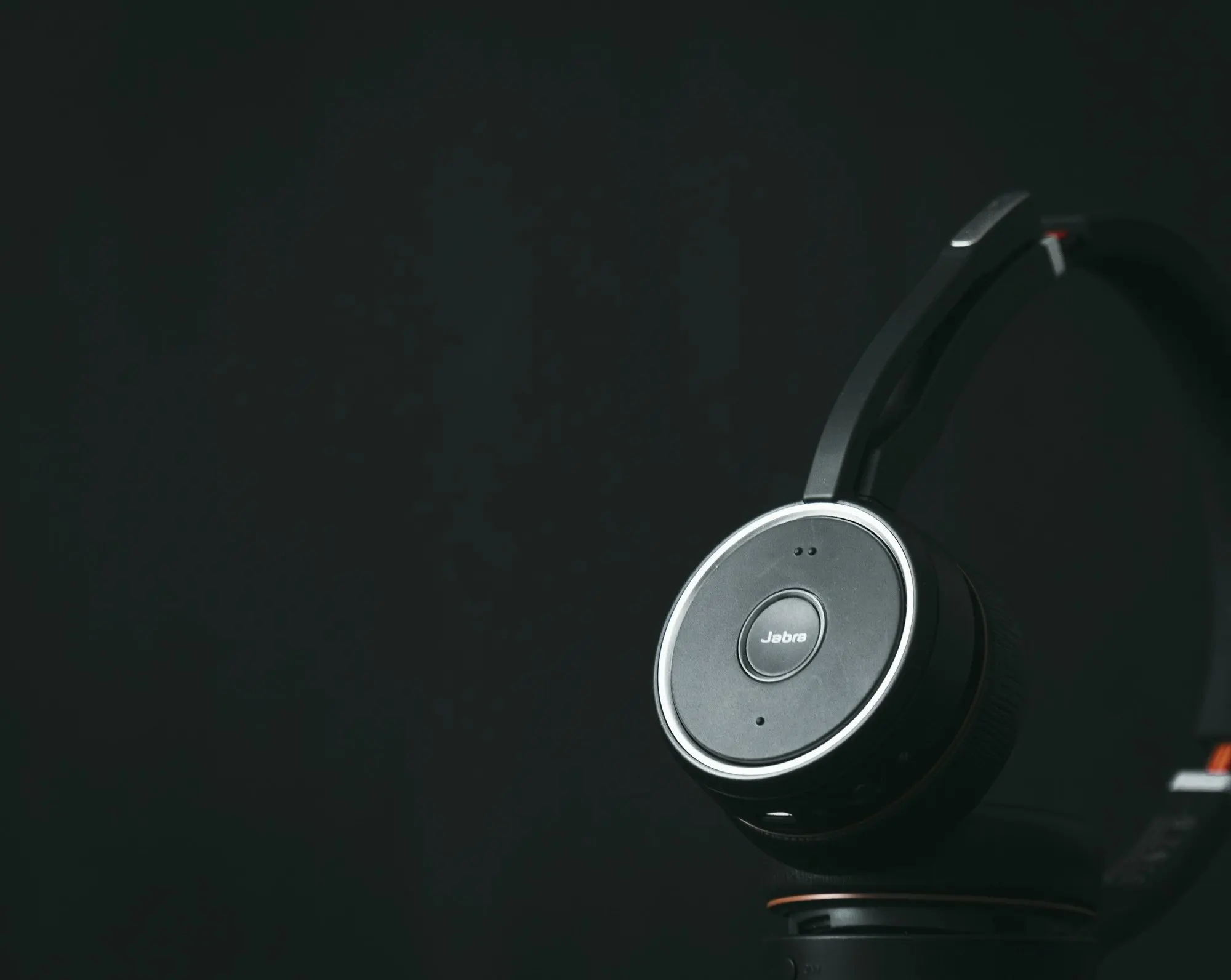 A headset with a microphone resting on a bright desk.