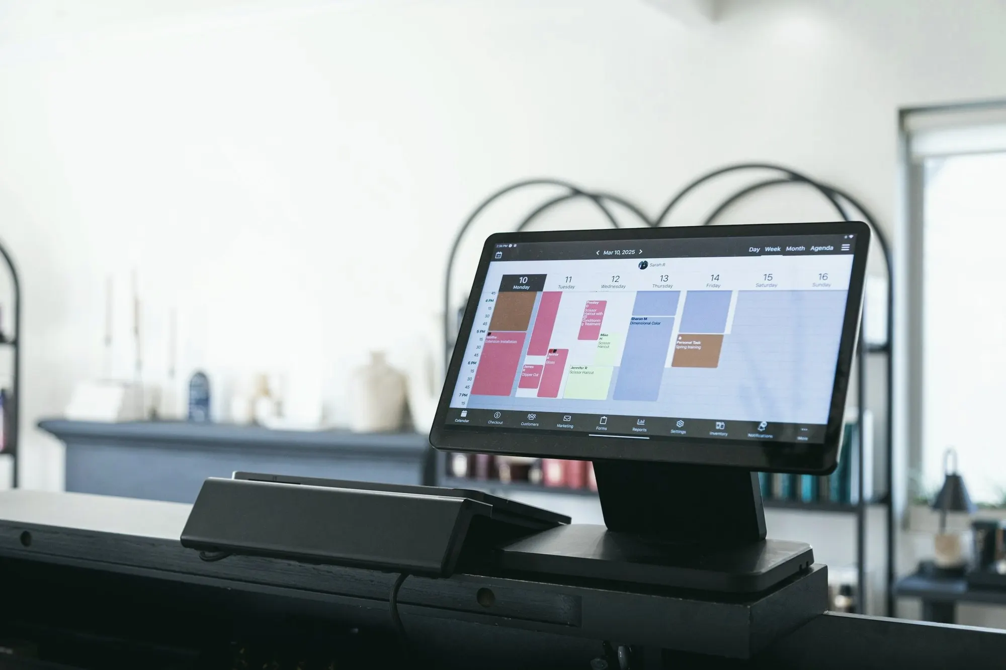 A point-of-sale touchscreen on a bright retail counter.